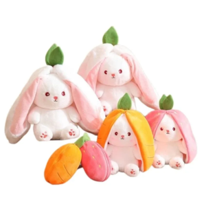 A collection of plush toys featuring two bunnies with long ears and leaves atop their heads, and two bunnies partially enveloped in colorful fruit peelings resembling costumes, with a peach and a strawberry plush toy in front, against a white background.