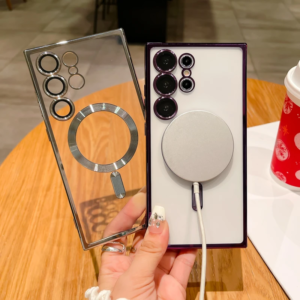 A person holding a clear smartphone case next to a purple smartphone with multiple camera lenses and a magnetic charger attached.