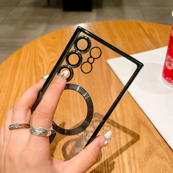 A person holding a black optical illusion frame with overlapping circles creating a visual effect, displayed against a wooden table background with a red soda can and a white plate in view.