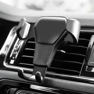 Close-up of a monochrome car air vent with a leather-wrapped mobile phone holder clipped onto it.